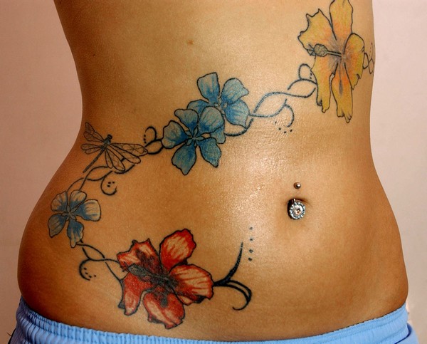 Belly Button Piercing And Hip Tattoo