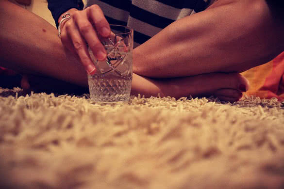 female legs and the glass of water